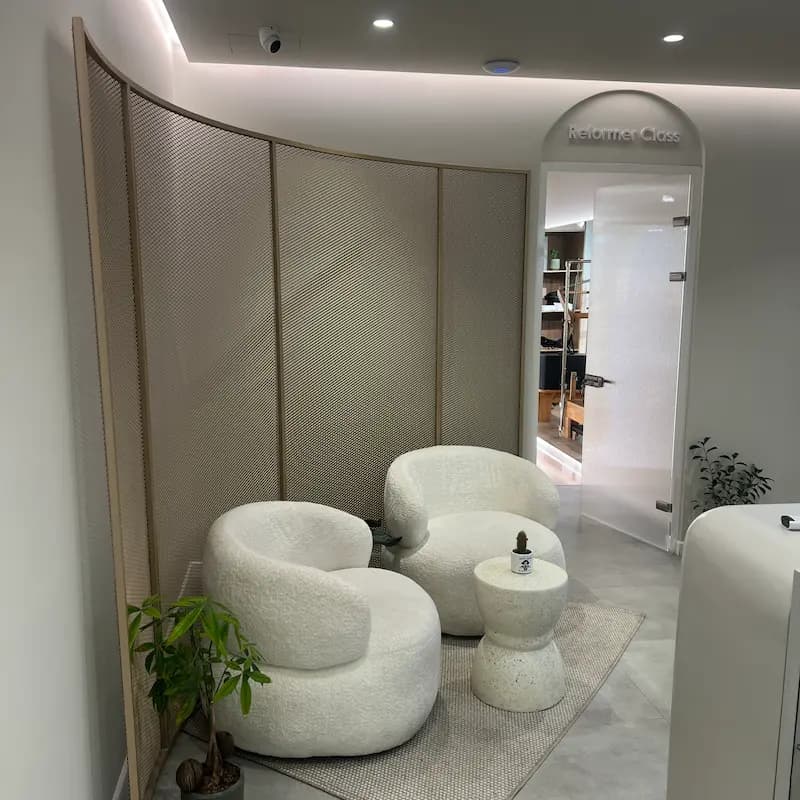 Lounge seating next to the Reformer Room entrance at ANIMO STUDIO
